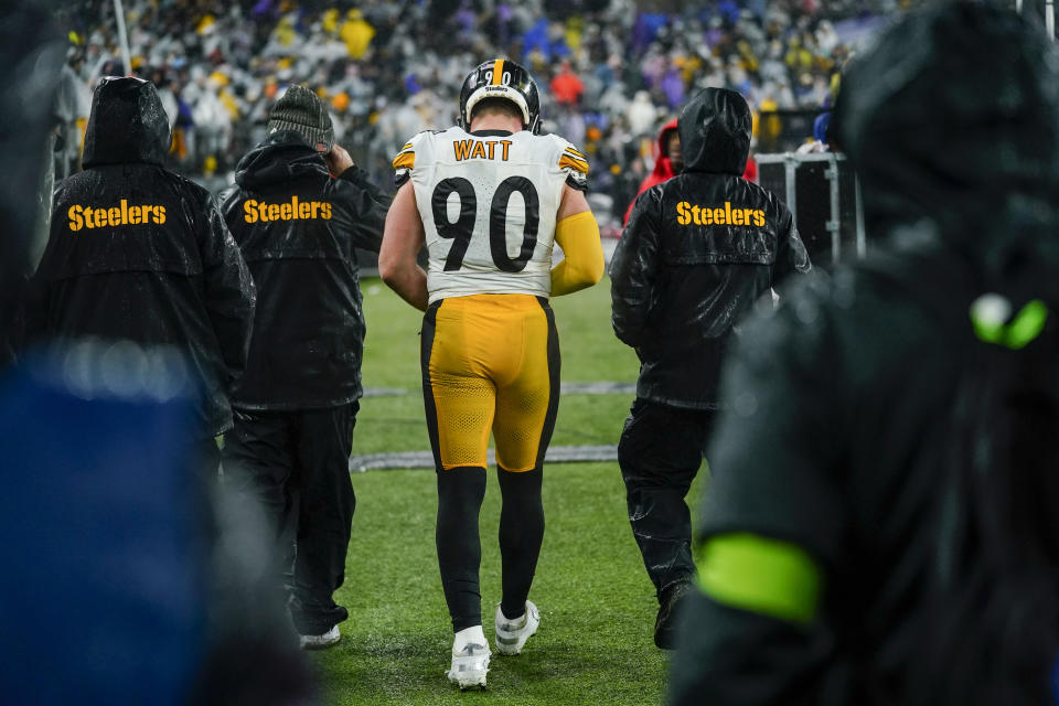 Pittsburgh Steelers linebacker T.J. Watt walks with medical staff to the lockers during the second half of an NFL football game against the Baltimore Ravens, Saturday, Jan. 6, 2024 in Baltimore. (AP Photo/Matt Rourke)