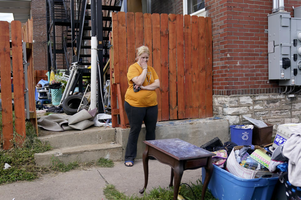 Kristen Bigogno stands on the sidewalk after being evicted from her home Friday, Sept. 17, 2021, in St. Louis. Bigogno is among thousands of Americans facing eviction now that the national moratorium has ended. (AP Photo/Jeff Roberson)