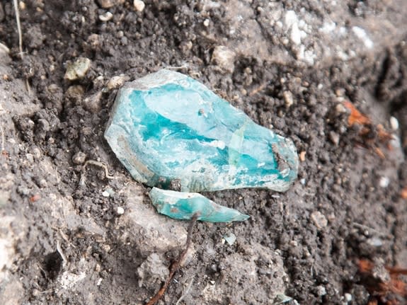 Turquoise-colored fragments of raw glass were found at what archaeologists are calling the oldest known glass factory in Israel.