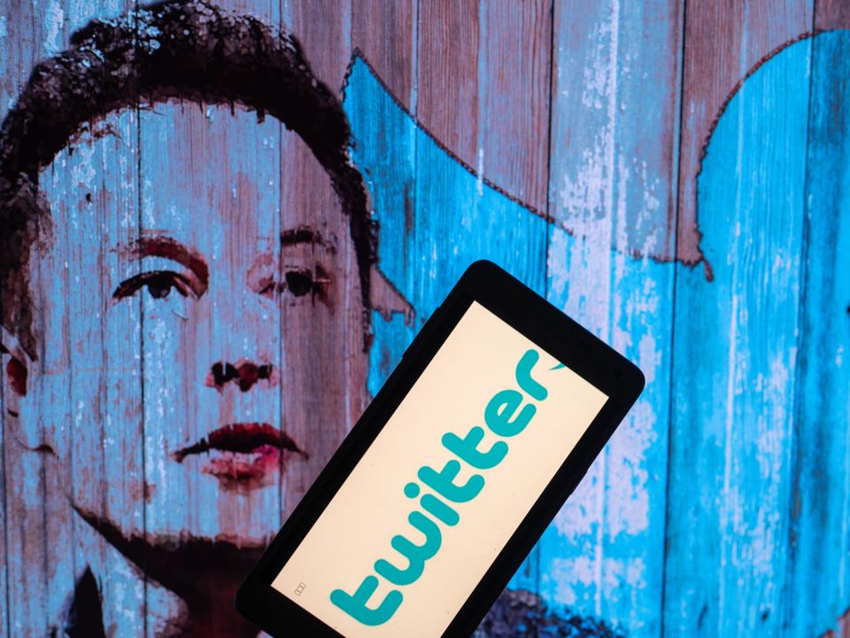 Elon Musk's Twitter account displayed on a mobile with Elon Musk in the background are seen in this illustration. In Brussels - Belgium on 19 November 2022. (Photo illustration by Jonathan Raa/NurPhoto via Getty Images)