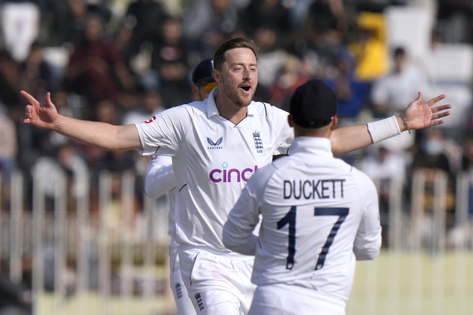 England's Ollie Robinson celebrates after taking the wicket of Pakistan's Saud Shakeel during the fifth day of the first test cricket match between Pakistan and England, in Rawalpindi, Pakistan, Monday, Dec. 5, 2022. (AP Photo/Anjum Naveed)