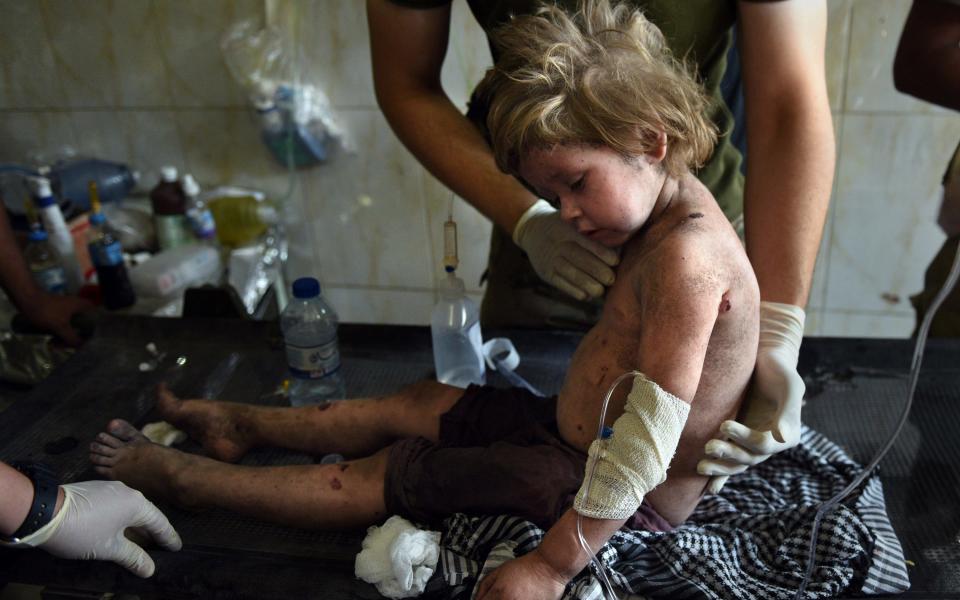 A little girl named Amina was found by Iraqi Army soldiers when they heard her cries from the rubble. She was believed to be foreign and spoke Russian.  - Credit: Carol Guzy/Rex