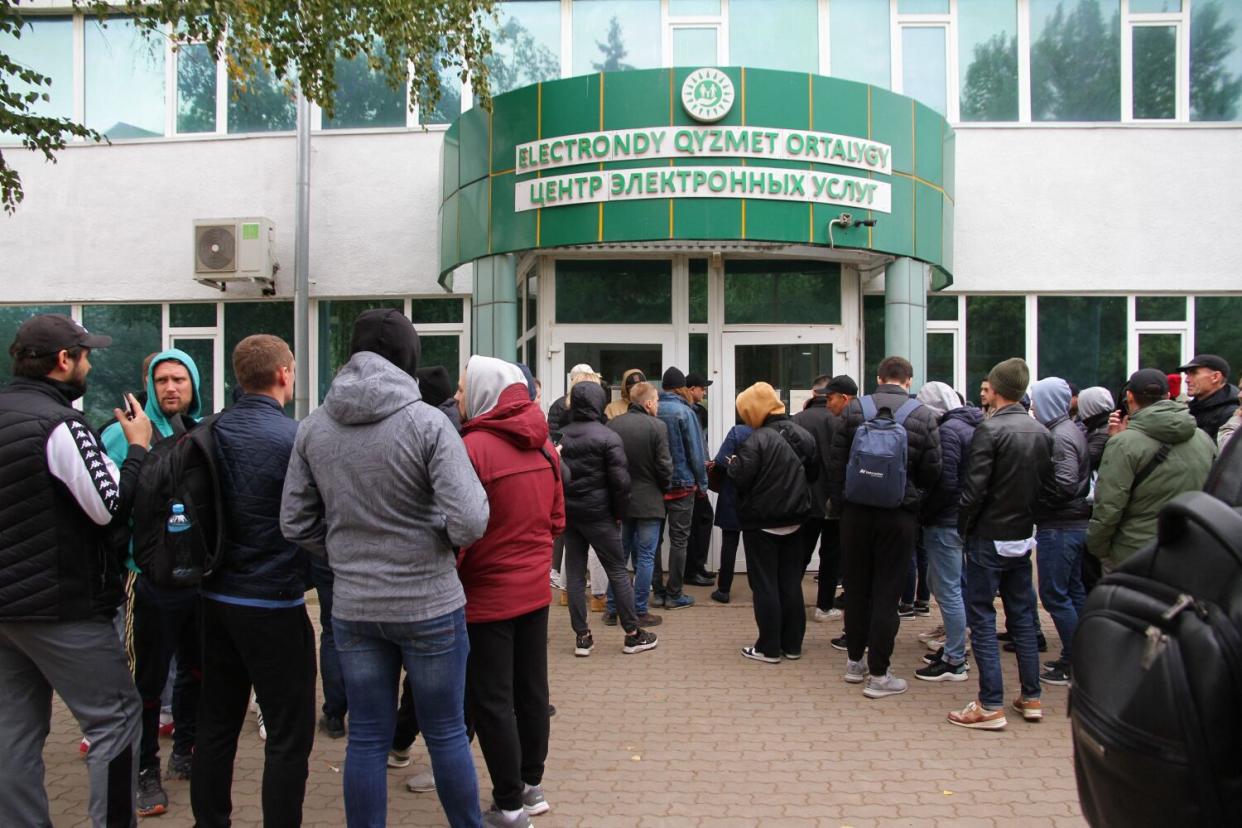 People line up outside a building.