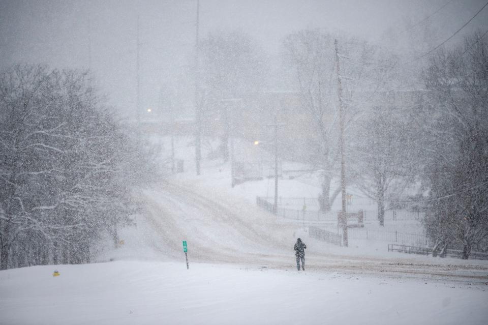 A snow storm blankets Western Ave. that devoid of vehicles on Monday, January 15, 2024 in Knoxville, Tenn.