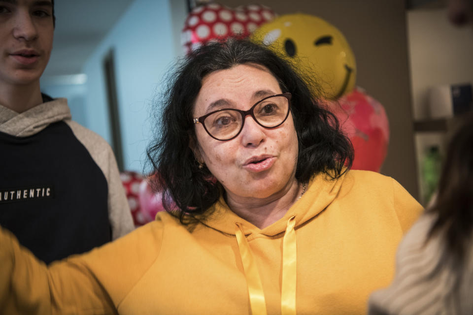 Alina Chubattaya, the director of a children's home talks after the arrival of children from an orphanage in Odesa, Ukraine, at a hotel in Berlin, Friday, March 4, 2022. More than 100 Jewish refugee children who were evacuated from a foster care home in war-torn Ukraine and made their way across Europe by bus have arrived in Berlin. “My husband, my daughter, my son and my dog, are all still in Odesa,” she said with a sad smile. “My heart is there, too," she added. "But I also wanted to take these kids here to safety.” (AP Photo/Steffi Loos)