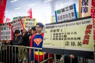 Demonstrators display placards against Hong Kong Chief Executive Leung Chun-ying prior to his policy address on January 16, 2013. Leung who won office after he campaigned promising to improve the lives of poor and middle-class citizens, was to give his first policy address amid discontent over issues including sky-high property prices and anti-Beijing sentiment