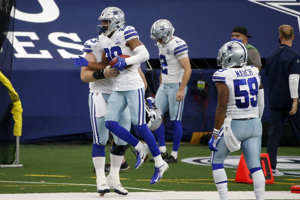 Dallas Cowboys' C.J. Goodwin (29) celebrates with Justin March (59) and others after recovering an onside kick in the second half of an NFL football game against the Atlanta Falcons in Arlington, Texas, Sunday, Sept. 20, 2020. (AP Photo/Michael Ainsworth)