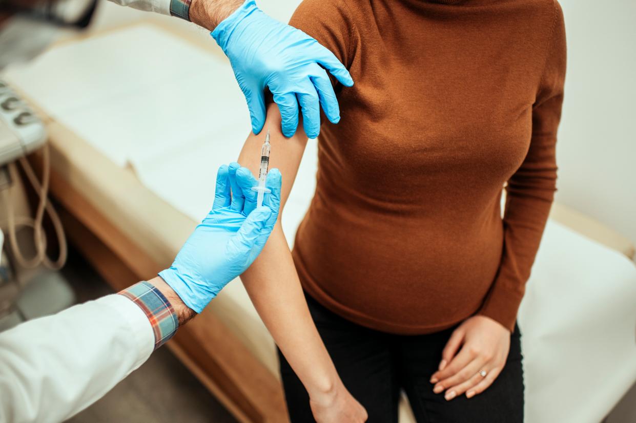 A pregnant woman getting vaccinated against flu or coronavirus (Getty Images)