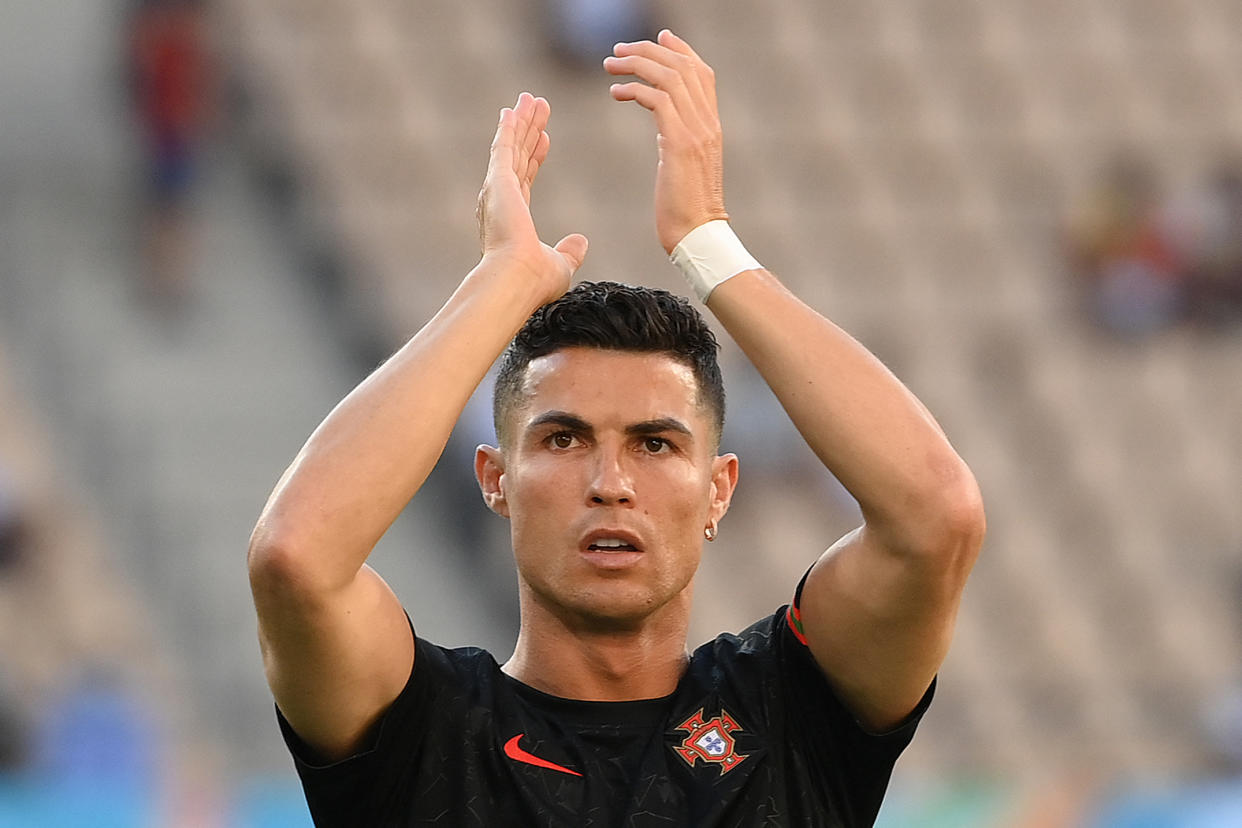 Portugal's forward Cristiano Ronaldo applauds during the warming-up before the UEFA EURO 2020 round of 16 football match between Belgium and Portugal at La Cartuja Stadium in Seville on June 27, 2021. (Photo by LLUIS GENE / POOL / AFP) (Photo by LLUIS GENE/POOL/AFP via Getty Images)