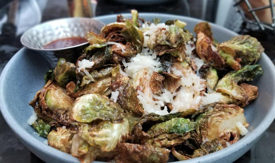 The crispy brussels sprouts with melted slivers of Manchego are served with a sriracha agave at Overture restaurant inside the Art Ovation Hotel in downtown Sarasota.