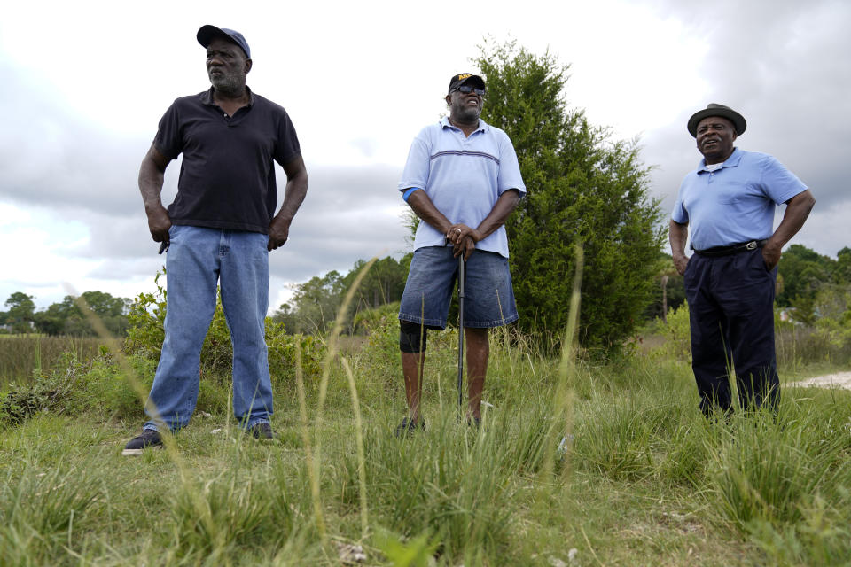 Richard Habersham, from left, Fred Smalls, and Jonathan Ford, give a tour of their neighborhood Thursday, July 27, 2023, in Phillips Community, an unincorporated area near Mount Pleasant, S.C. (AP Photo/Erik Verduzco)