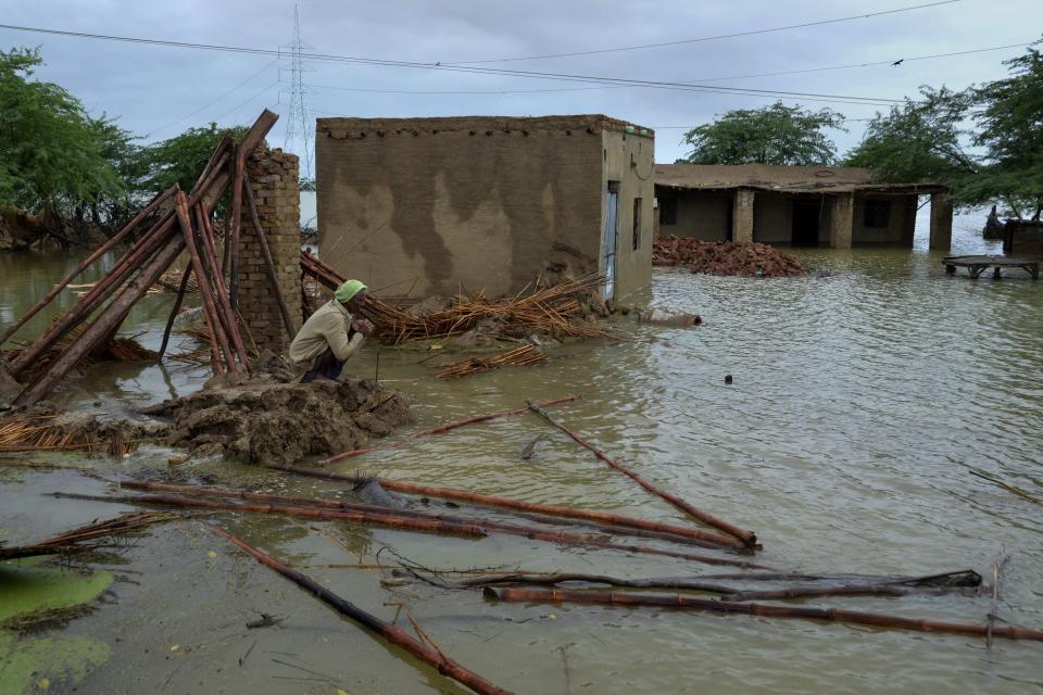 A man looks too his flood-hit home in Jaffarabad, a district of Pakistan's southwestern Baluchistan province, Thursday, Aug. 25, 2022. Pakistan's government in an overnight appeal sought relief assistance from the international community for flood-affected people in this impoverished Islamic nation, as the exceptionally heavier monsoon rain in recent decades continued lashing various parts of the country. (AP Photo/Zahid Hussain)