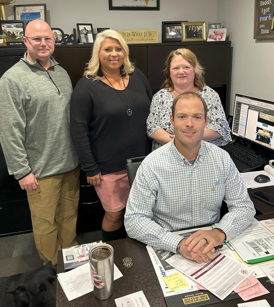 Glascock Sheriff Jeremy Kelley, seated, poses with officials from the Georgia Sheriff's Association during his office's final review for accreditation.
