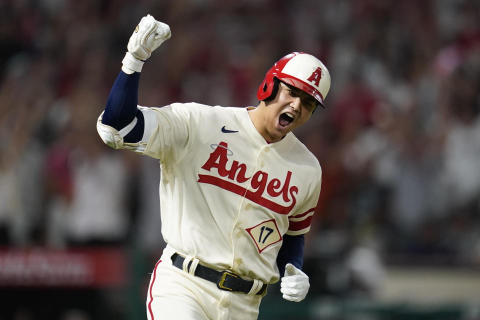 Los Angeles Angels designated hitter Shohei Ohtani (17) reacts as he runs the bases after hitting a home run during the sixth inning of a baseball game against the New York Yankees in Anaheim, Calif., Wednesday, Aug. 31, 2022. David Fletcher and Mike Trout also scored. (AP Photo/Ashley Landis)