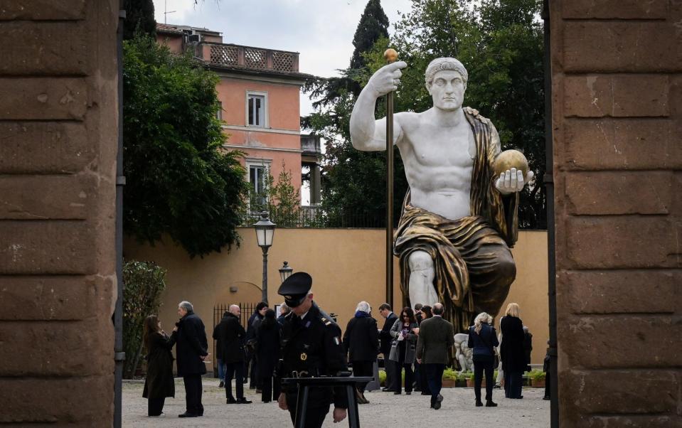 People attend the press preview of the reconstructed statue depicting Emperor Constantine