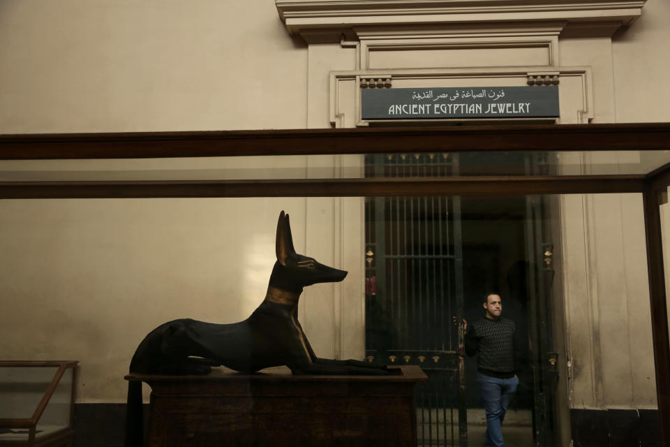 In this Wednesday, Oct. 30, 2013 photo, an associate curator waits for visitors in the Egyptian Museum near Tahrir Square in Cairo, Egypt. The 111-year-old museum, a treasure trove of pharaonic antiquities, has long been one of the centerpieces of tourism to Egypt. But the constant instability since the 2011 uprising that toppled autocrat Hosni Mubarak has dried up tourism to the country, slashing a key source of revenue. Moreover, political backbiting and attempts to stop corruption have had a knock-on effect of bringing a de facto ban on sending antiquities on tours to museums abroad, cutting off what was once a major source of funding for the museum. (AP Photo/Nariman El-Mofty)