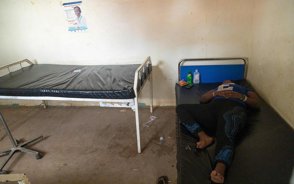 A suspected Ebola patient rests on the bed at Madudu Health center 3 waiting to be transferred to an isolation unit in Mubende, Uganda - BADRU KATUMBA/AFP via Getty Images