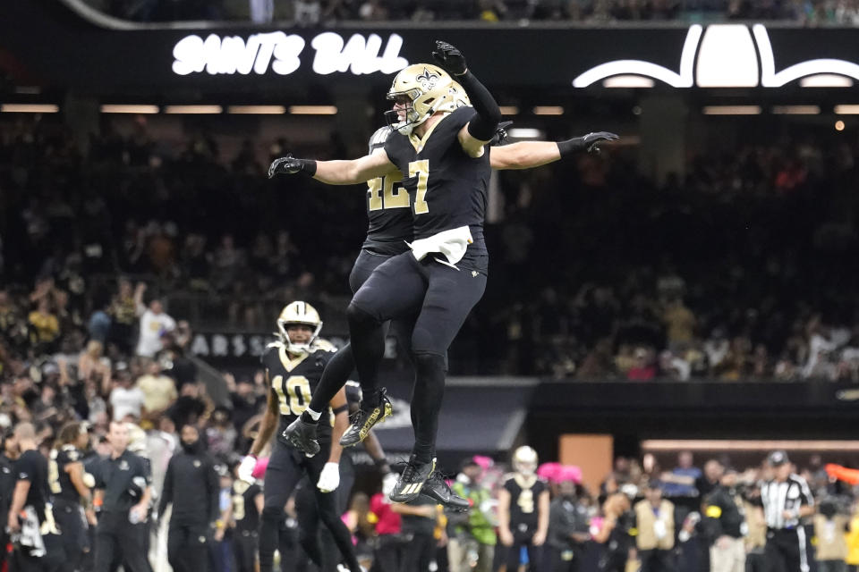 New Orleans Saints' Taysom Hill (7) and Chase Hansen celebrate after Hill recovered a fumble on a Seattle Seahawks fake punt during an NFL football game in New Orleans, Sunday, Oct. 9, 2022. (AP Photo/Gerald Herbert)