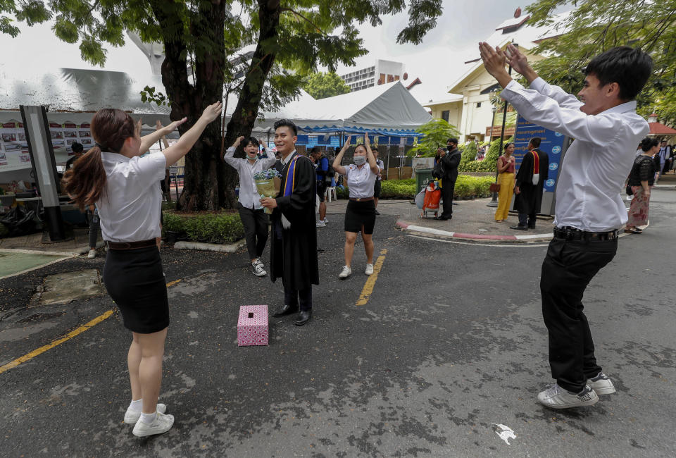 University students celebrate ahead of a graduation ceremony of a fellow student at the Thammasat University, Friday, Oct. 30, 2020, in Bangkok, Thailand. (AP Photo/Sakchai Lalit)