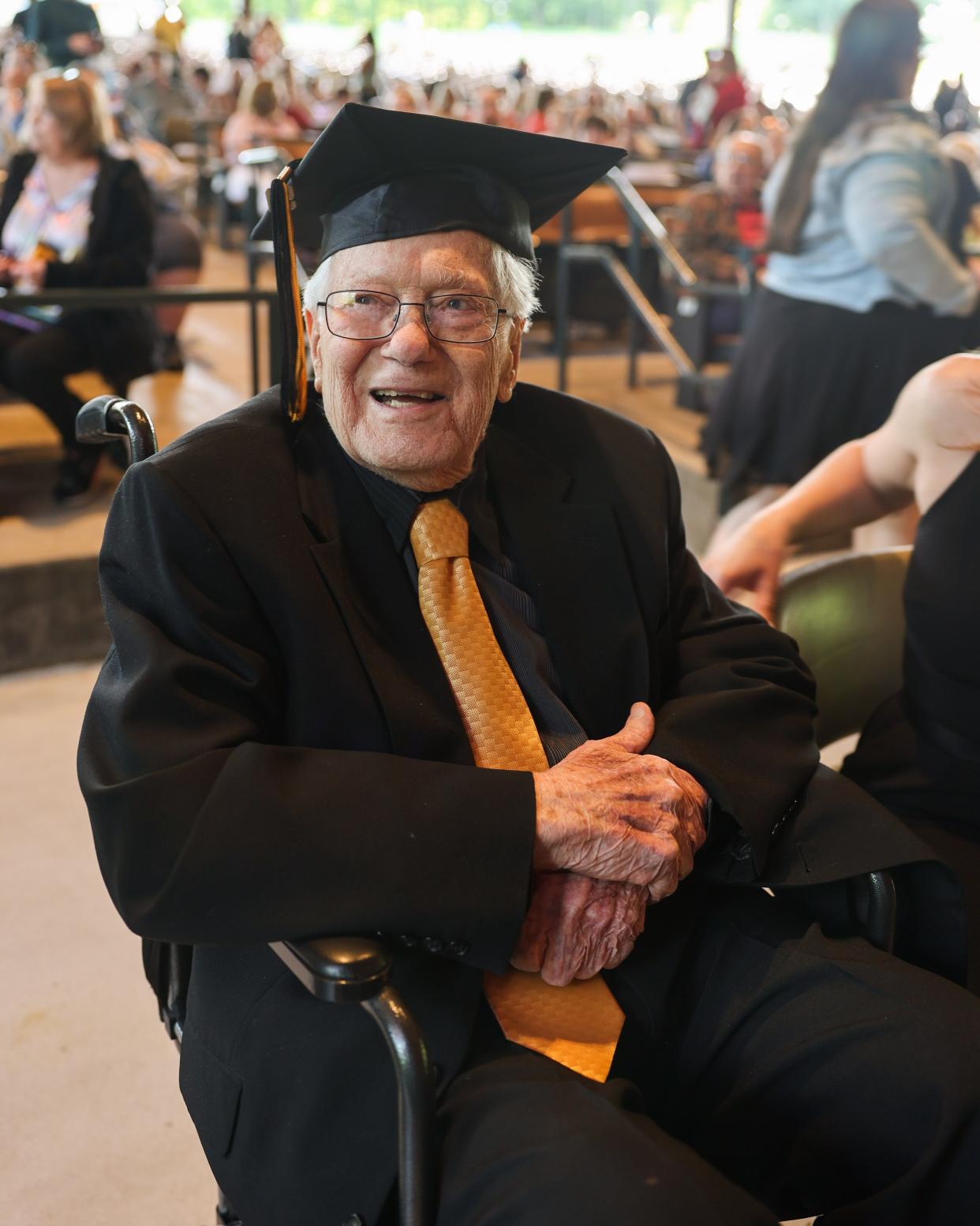 Graduate Libert Bozzelli, 97, waits for the Cuyahoga Falls High School commencement ceremony to begin in May.