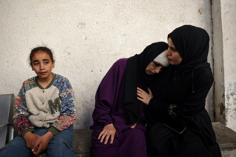 A Palestinian woman mourns her children killed in Israeli bombing in Rafah in the southern Gaza Strip (-)
