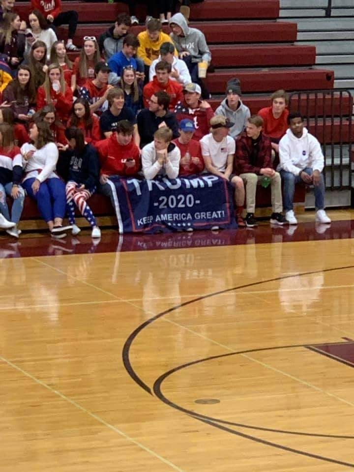 Basketball spectators watching a game between Roosevelt High School and Jordan High School in Minnesota held up a pro-Trump flag. (Photo: Michael Zeke Walker via Facebook)