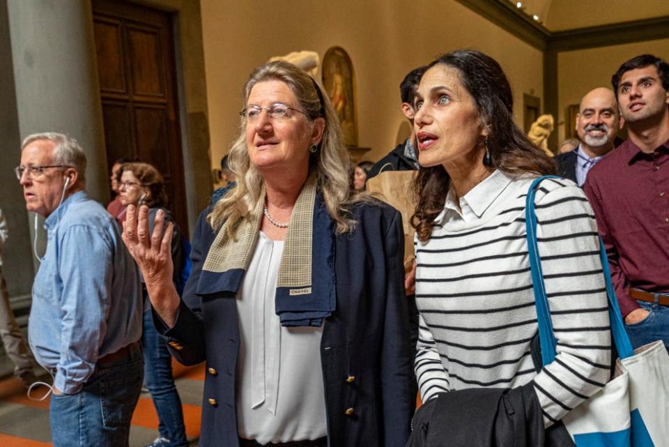 This image provided by Galleria dell'Accademia di Firenze shows former Dean of the Tallahassee Classical School, FL, Hope Carrasquilla, right, with museum director Cecilie Hollberg looking at Michelangelo Buonarroti's colossal marble statue 'David', in Florence, central Italy, on April 28, 2023.