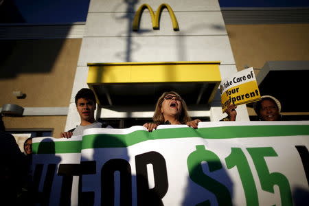 Fast-food workers and their supporters join a nationwide protest for higher wages and union rights outside McDonald's in Los Angeles, California, United States, November 10, 2015. REUTERS/Lucy Nicholson