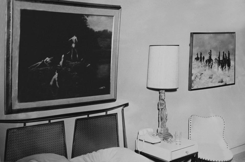 This Nov. 22, 1963 photo provided by Amon Carter Museum of American Art Archives shows the paintings Thomas Eakins', Swimming and Charles M. Russell's, Lost in a Snowstorm in Suite 850 at the Hotel Texas, in Fort Worth, Texas. An exhibit opening next year at the Dallas Museum of Art will feature almost all of the works of art gathered from museums and prominent Fort Worth citizens for the hotel suite John F. Kennedy and first lady Jacqueline Kennedy stayed in the night before he was assassinated. (AP Photo/ Amon Carter Museum of American Art Archives, Byron Scott)