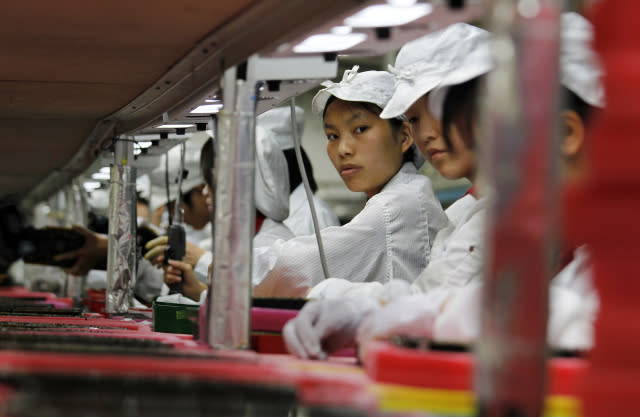 Workers are seen inside a Foxconn factory in the township of Longhua in the southern Guangdong province May 26, 2010. A spate of nine employee deaths at global contract electronics manufacturer Foxconn, Apple's main supplier of iPhones, has cast a spotlight on some of the harsher aspects of blue-collar life on the Chinese factory floor.   REUTERS/Bobby Yip  (CHINA - Tags: BUSINESS EMPLOYMENT)    FOR BEST QUALITY IMAGE ALSO SEE: GF2E9AP0D4F01 - GM1E65Q1D4Y01
