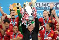 Manchester United manager Sir Alex Ferguson lifts the Barclays Premier League trophy, after the game