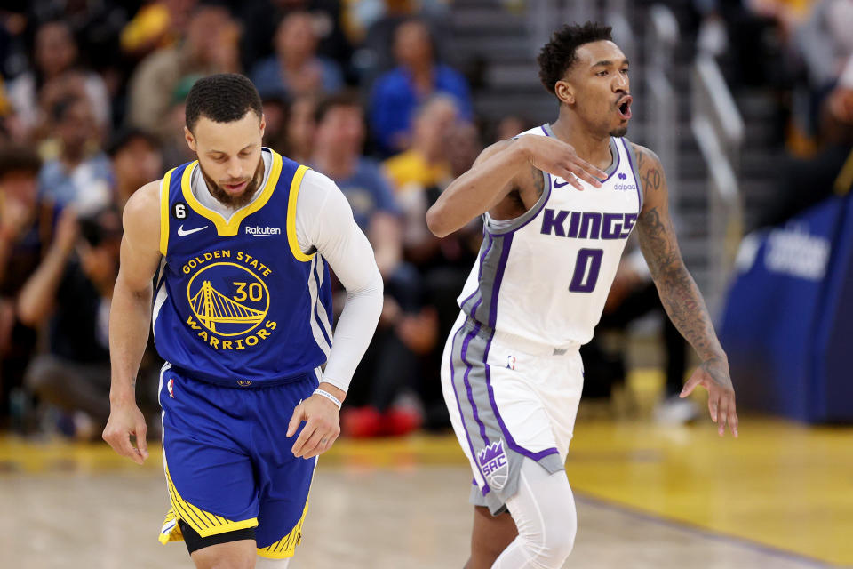 Sacramento's Malik Monk reacts after making a basket next to Golden State's Stephen Curry in Game 6 of their NBA playoffs first-round series at the Chase Center in San Francisco on April 28, 2023. (Ezra Shaw/Getty Images)