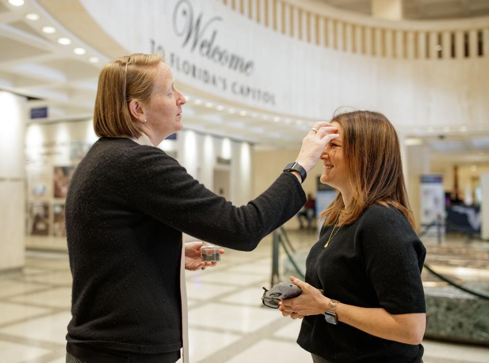 While at the Florida Capitol, people pause to pray and receive ashes as part of the Ash Wednesday tradition, March 2, 2022.