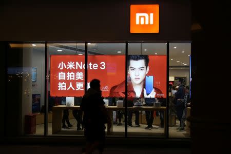 People walk past a Xiaomi store in Beijing, China March 31, 2018. REUTERS/Stringer/Files