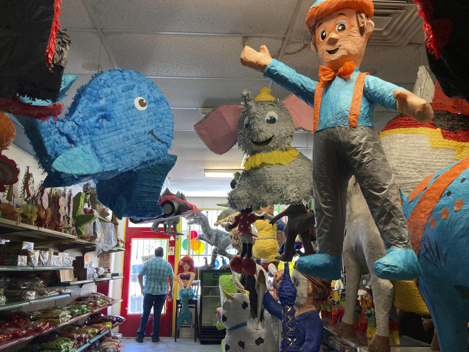 Francisco Rodríguez looks out the window of his shop Casa de Piñatas in Albuquerque, N.M., Sept. 7, 2023. Rodríguez said many older piñata artists have retired but he's hopeful the next generation will take an interest in the craft. On Friday, Sept. 8, the U.S. Postal Service released its latest collection of special stamps, this time highlighting the piñata as part of a monthlong recognition of Hispanic heritage in the U.S. (AP Photo/Susan Montoya Bryan)