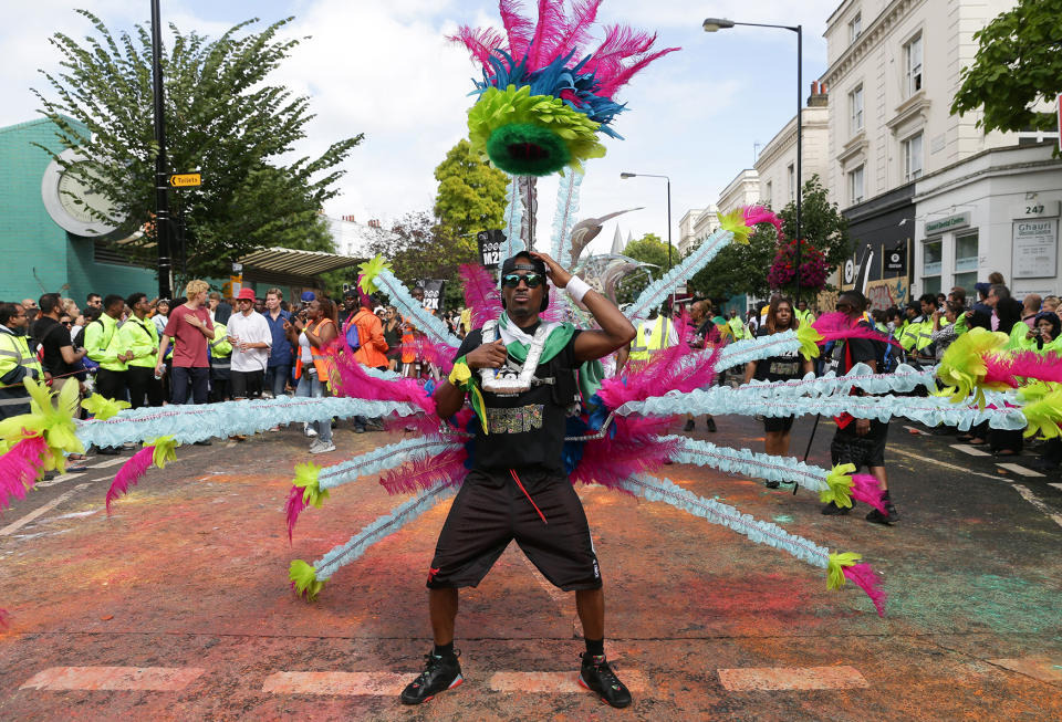 <p>Performers in costume parade on the first day of the Notting Hill Carnival in west London on August 28, 2016. (Photo: DANIEL LEAL-OLIVAS/AFP/Getty Images) </p>