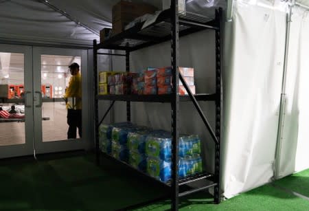 Water and snacks sit on shelves for asylum-seekers at the Donna Soft-Sided Processing Facility in Donna, Texas