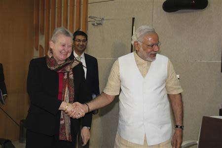 U.S. ambassador to India Nancy Powell (L) shakes hands with Hindu nationalist Narendra Modi (R), prime ministerial candidate for India's main opposition Bharatiya Janata Party (BJP) and Gujarat's chief minister, during their meeting in Gandhinagar in the western Indian state of Gujarat February 13, 2014. REUTERS/Gujarat Information Department/Handout via Reuters
