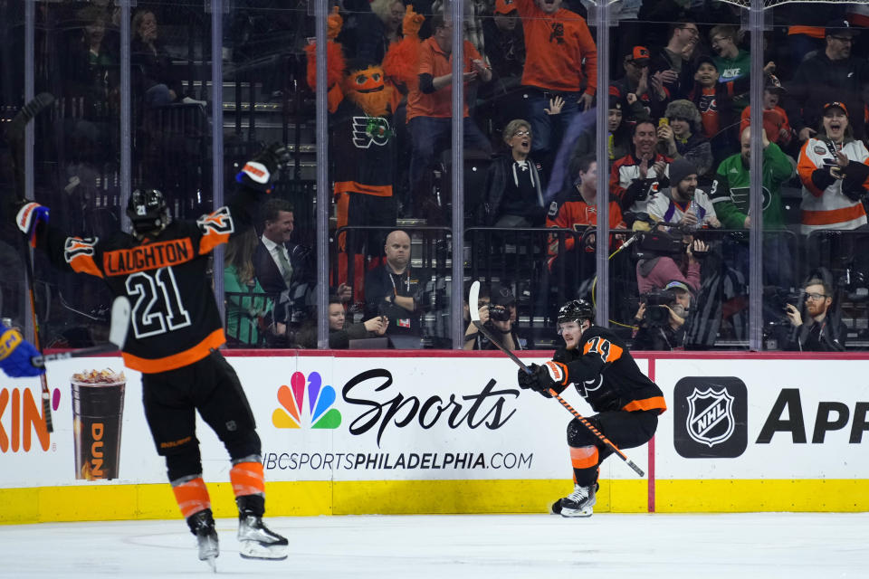 Philadelphia Flyers' Owen Tippett (74) celebrates with Scott Laughton (21) after scoring a goal during the third period of an NHL hockey game against the Buffalo Sabres, Friday, March 17, 2023, in Philadelphia. (AP Photo/Matt Slocum)
