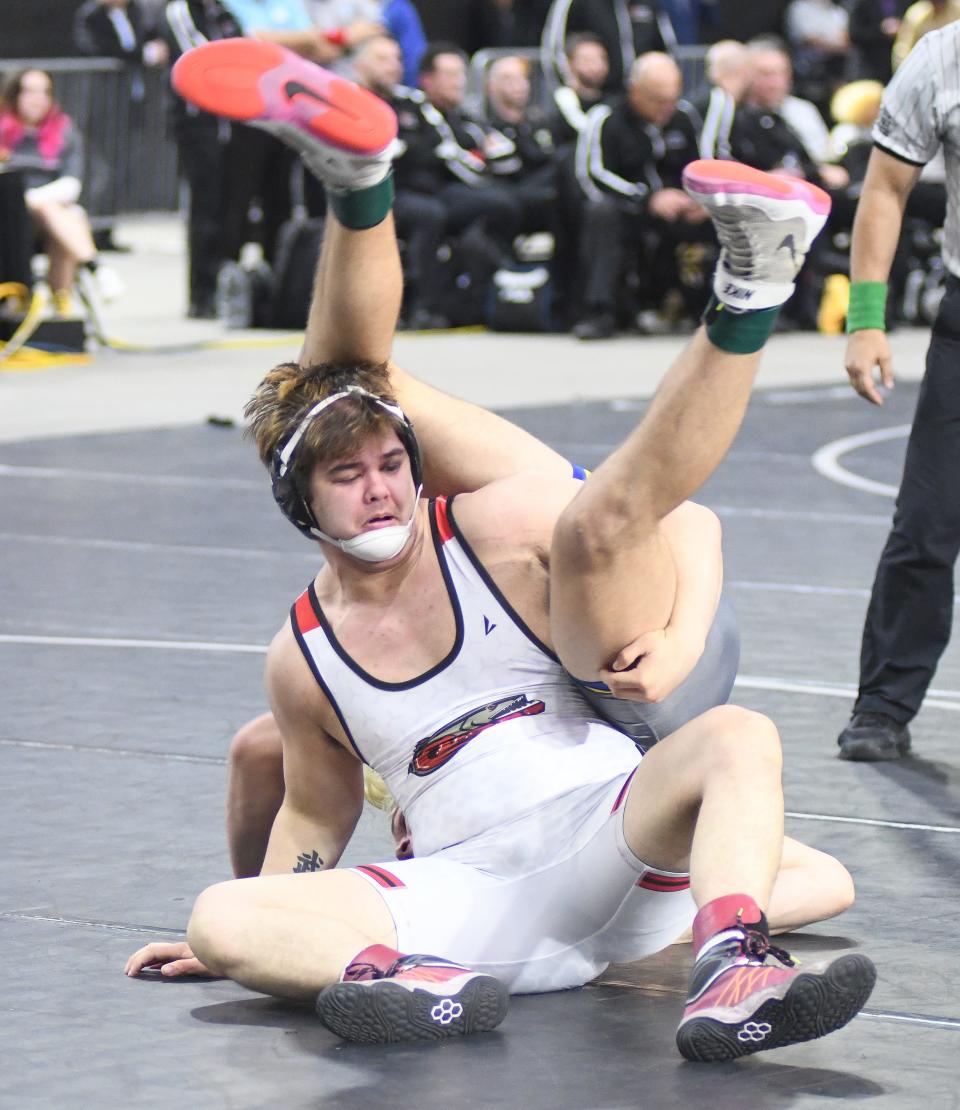 New Smyrna Beach's Dylon York flips Charlotte High's Cael Newton during their Class 2A 220-pound final Saturday, March 4, 2023, at the FHSAA State Wrestling Championships at the Silver Spurs Arena in Kissimmee. Newton won the match by fall in 1:43.