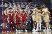 Washington players huddle at right as Utah players look on during the second half of an NCAA college basketball game, Sunday, Jan. 24, 2021, in Seattle. Washington won 83-79. (AP Photo/Ted S. Warren)
