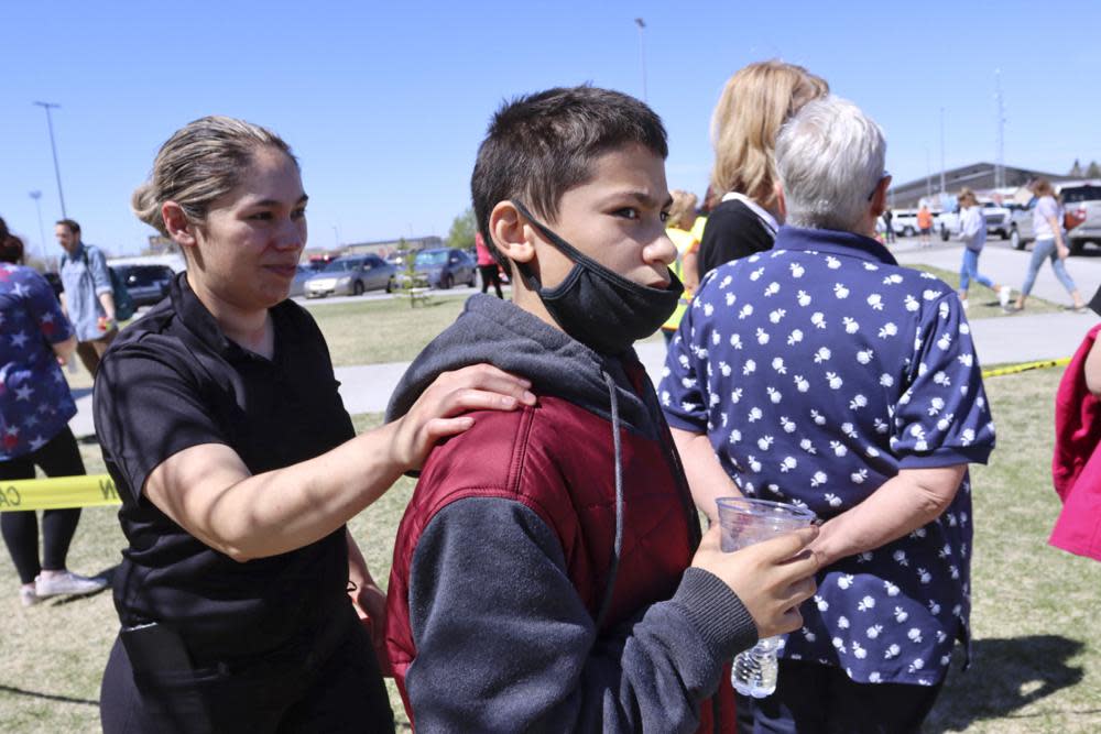 Alela Rodriguez, left, walks with her son, Yandel Rodriguez, 12, at the high school where people were evacuated after a shooting at the nearby Rigby Middle School earlier Thursday, May 6, 2021, in Rigby, Idaho. (AP Photo/Natalie Behring)