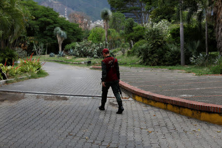 A Venezuelan National Guard member walks at the entrance of the botanical garden in Caracas, Venezuela July 9, 2018. Picture taken July 9, 2018. REUTERS/Marco Bello