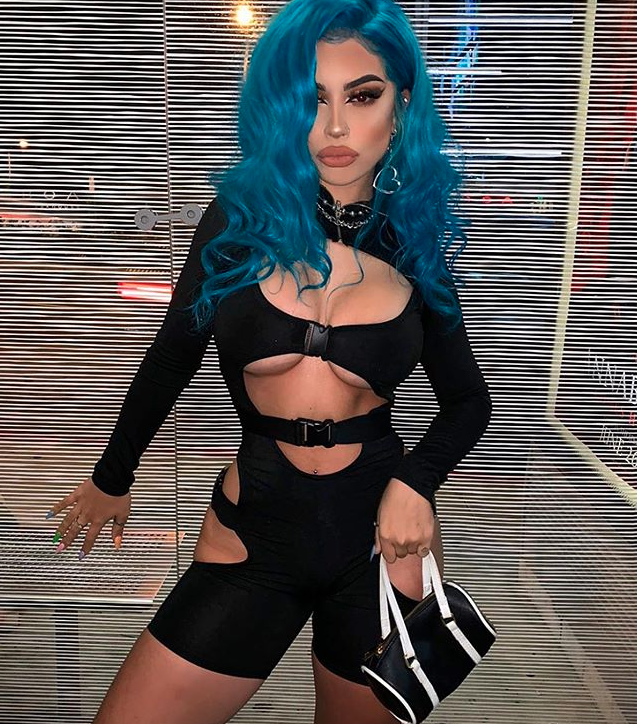 Woman with blue hair in cut out black romper