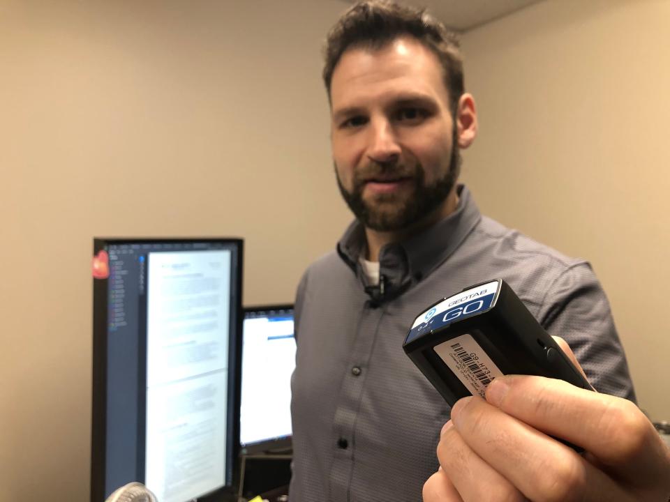 Ryan Rodts, St. Joseph County's fleet director, shows a tracking device that the county is installing in all of its vehicles. He'll track data from the cars' usage on the computer screens here in his office.