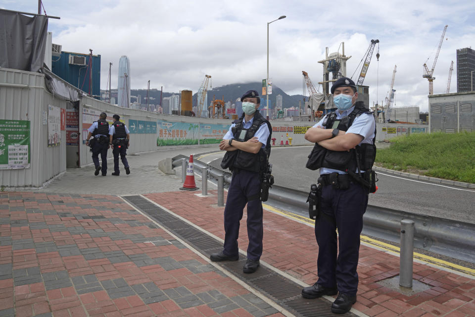 Police officers patrol outside the high speed train station for the Chinese president Xi Jinping's visit to mark the 25th anniversary of Hong Kong handover to China, in Hong Kong, Thursday, June 30, 2022. (AP Photo/Kin Cheung)