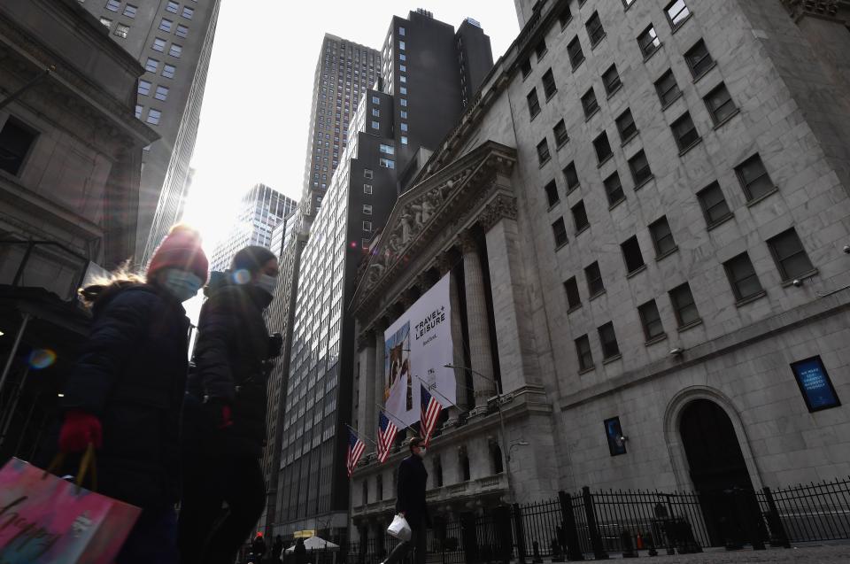 People walk past the New York Stock Exchange (NYSE) at Wall Street on February 17, 2021 in New York City. - Wall Street stocks retreated early Wednesday as worries about potentially higher inflation accompanied much better-than-expected US retail sales. (Photo by Angela Weiss / AFP) (Photo by ANGELA WEISS/AFP via Getty Images)