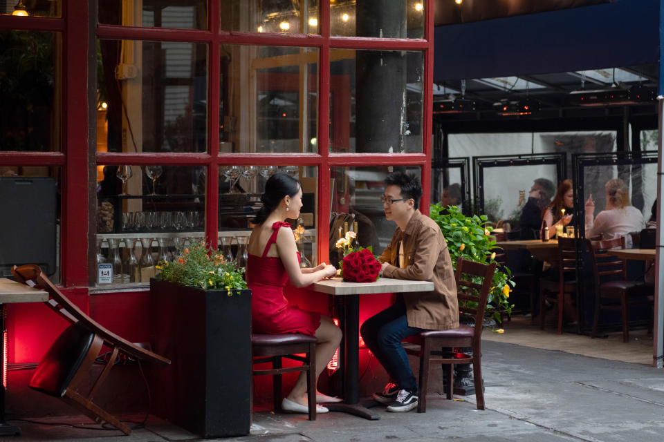 NEW YORK, NEW YORK - MAY 29: A couple sits at an outdoor restaurant on Memorial Day weekend on May 29, 2021 in New York City. On May 19, 2021 all pandemic restrictions, including mask mandates, social distancing guidelines, venue capacities and restaurant curfews were lifted by New York Governor Andrew Cuomo. (Photo by Alexi Rosenfeld/Getty Images)