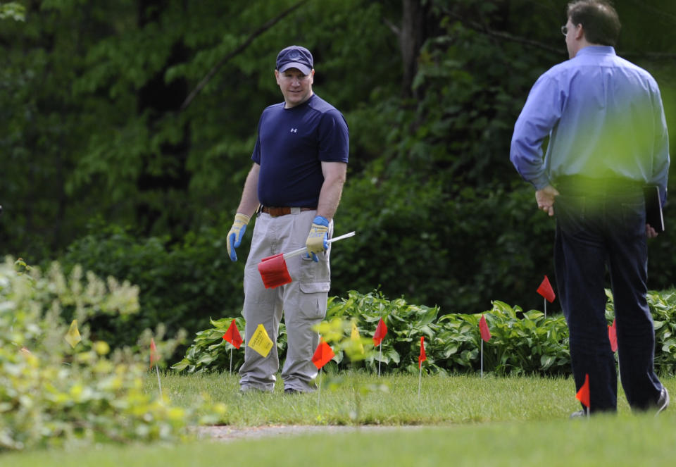 Law enforcement agents search the back yard of the home of reputed Connecticut mobster Robert Gentile in Manchester, Conn., Thursday, May 10, 2012. Gentile's lawyer A. Ryan McGuigan says the FBI warrant allows the use of ground-penetrating radar and believes they are looking for paintings stolen from Boston's Isabella Stewart Gardener Museum worth half a billion dollars. (AP Photo/Jessica Hill)