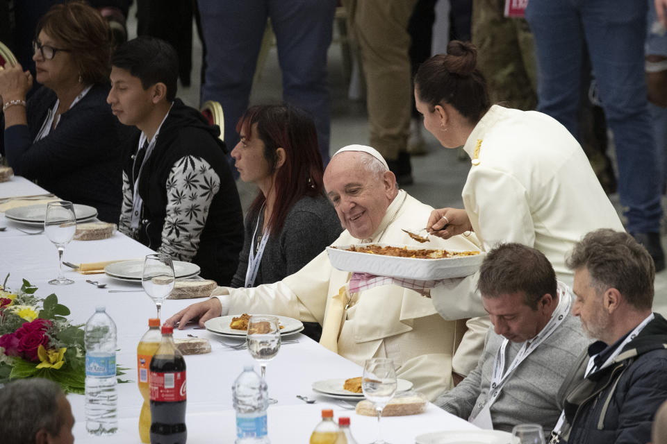 Pope Francis sits at a table during a lunch, in the Paul VI Hall at the Vatican, Sunday, Nov. 17, 2019. Pope Francis is offering several hundred poor people, homeless, migrants, unemployed a lunch on Sunday as he celebrates the World Day of the Poor with a concrete gesture of charity in the spirit of his namesake, St. Francis of Assisi. (AP Photo/Alessandra Tarantino)